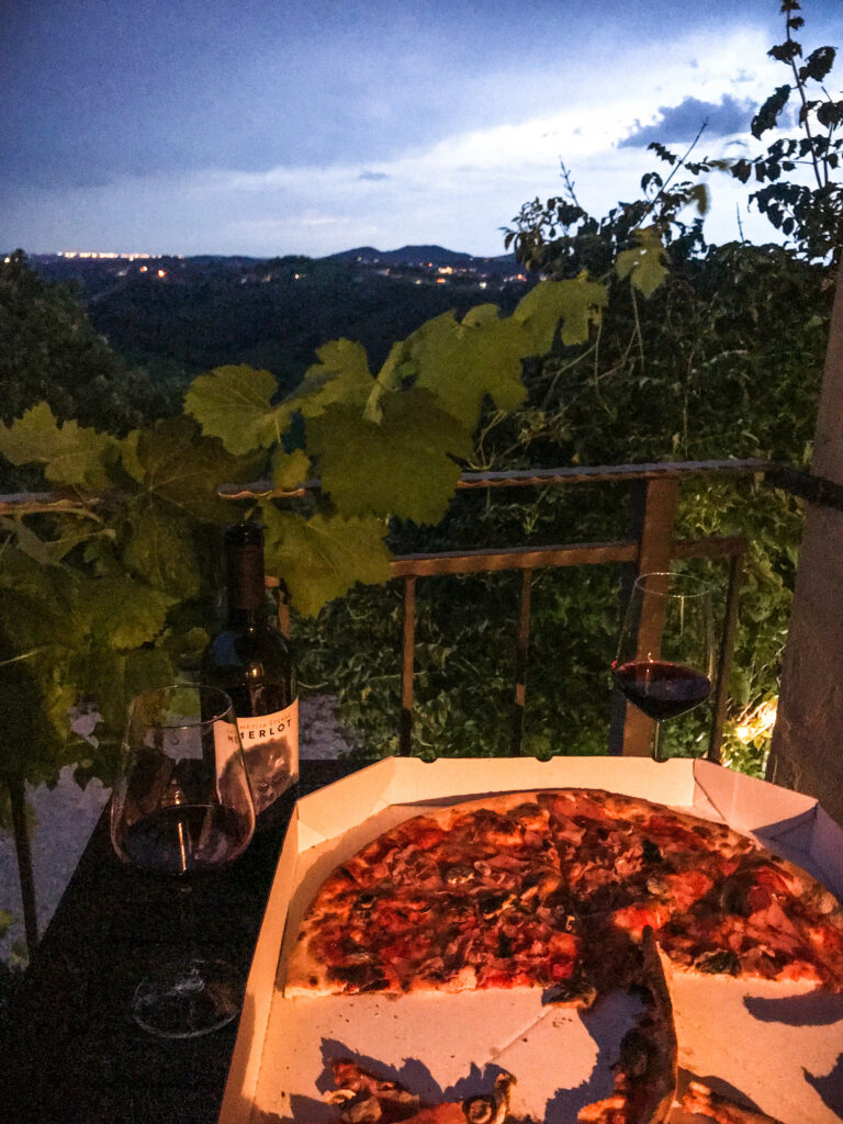 Slovenian wine and pizza enjoy at a balcony in Kojsko